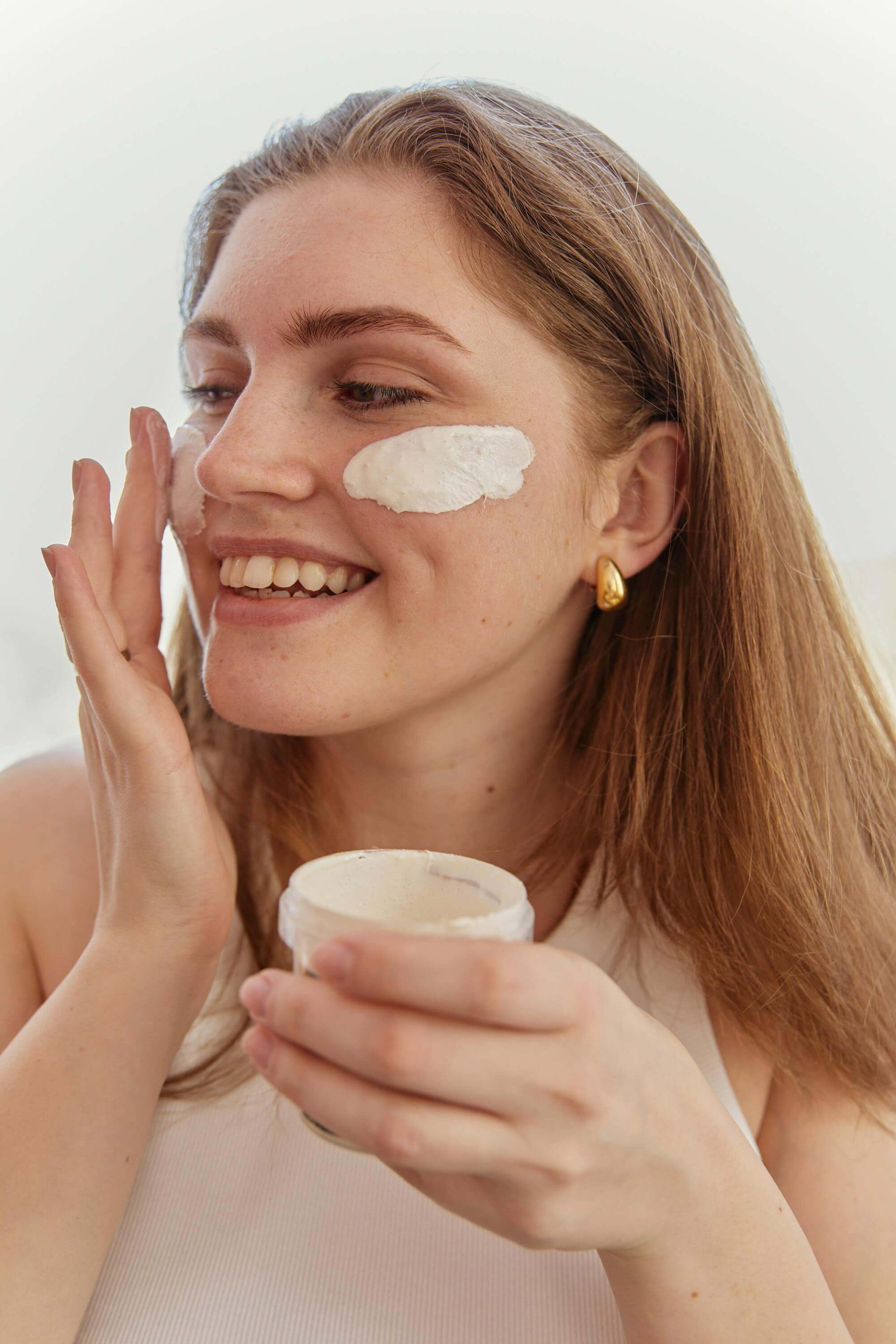 Woman applying a face cream